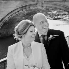 The bride and groom pose for a relaxed portrait in the town centre before their wedding reception