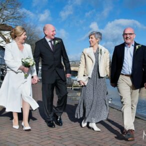 The bride and groom enjoy a stroll with their friends in the town before their Hotel Du Vin Henley wedding reception