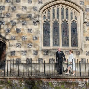 The bride and groom enjoy a walk past the historic church in the town centre
