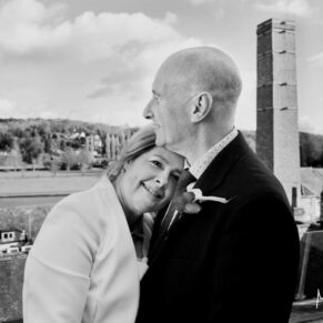 The bride and groom enjoy a cuddle on their terrace during their Hotel Du Vin Henley wedding reception