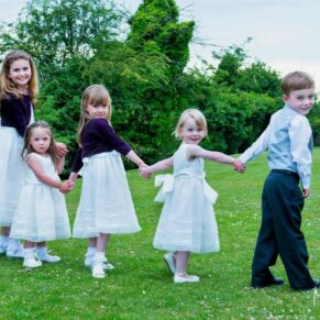 Photography of smiling young children captured running through the Latimer Estate's gardens on this wonderful wedding day