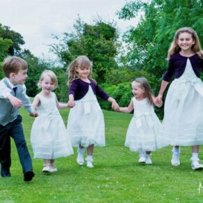Photography of giggling young children captured running through Latimer Estate's grounds on the wedding day