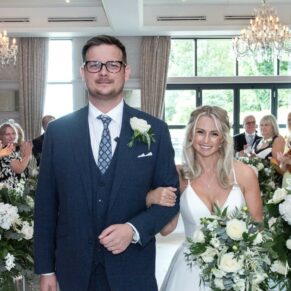 The smiling bride and groom exit the indoor civil ceremony at their Latimer Estate wedding