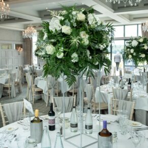 Photography of stunning white wedding floral arrangements inside the Cavendish Suite on the Latimer Estate