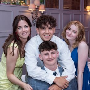 A very relaxed indoor group hug from some of the guests captured at the Latimer Estate during the drinks reception