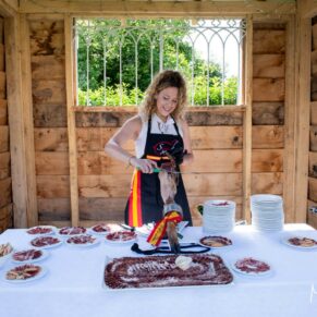 Yummy hand carved Iberico ham being prepared for the guests during the drinks reception at this Spanish wedding at Rackleys Barn