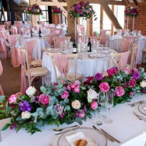 Striking floral displays used throughout Rackleys Barn for this vibrant wedding
