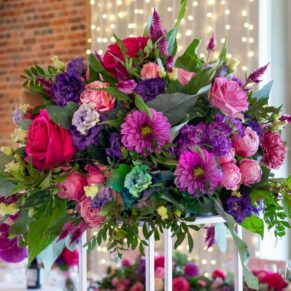 Striking floral table centre pieces used throughout Rackleys Barn for this colourful wedding
