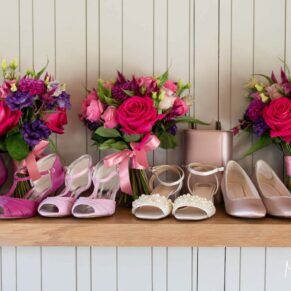 All the bridesmaids wedding bouquets and shoes gathered together for this colourful pose at Rackleys Barn
