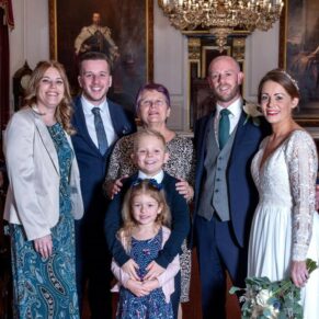 The newlyweds captured with some family members in a formal pose just after the civil ceremony at The Guildhall
