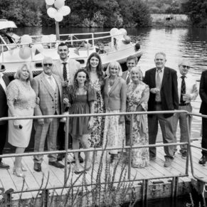 Photography of the wedding guests as they wait on the jetty for a short boat trip during this summer Bisham Abbey drinks reception