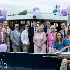 Photography of the wedding guests departing on a short boat trip during the Bisham Abbey drinks reception