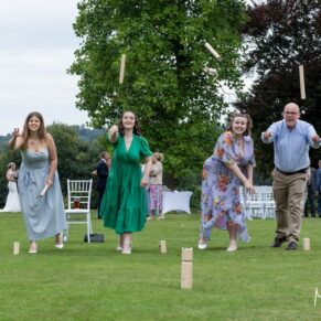 Photography of fun wedding games on the lawns at Bisham Abbey being enjoyed by the wedding guests