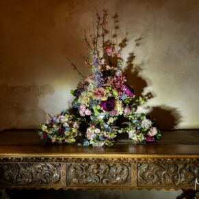 A striking wedding floral display captured inside the entrance to Bisham Abbey