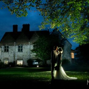 Once the light fades the magic really begins with the most dramatic effect! I carry my floodlighting to every wedding, then once the light fades I take the couple outdoors to illuminate the venue with the most striking results. For this pose at Bisham Abbey I'm lighting both the venue and the bride and groom with multiple lighting tricks. Photography of the bride and groom captured at dusk outside their Bisham Abbey wedding venue