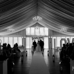 Photography of the marquee wedding civil ceremony in full swing at the Cotswolds Hotel, Golf and Spa