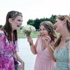Three ladies enjoying the banter on the outdoor terrace at this Cotswolds Hotel, Golf and Spa summer wedding