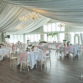 Photography wide angle view of marquee interior shot captured prior to the wedding breakfast at Cotswolds Hotel, Golf and Spa venue