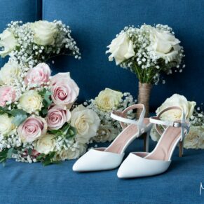 The bridal party place their gorgeous shoes and bouquets on a blue sofa for a photography opportunity at this Cotswolds Hotel, Golf and Spa wedding