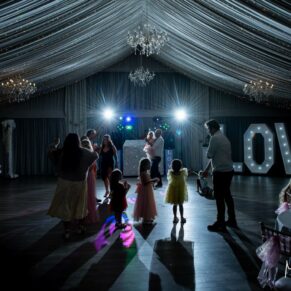 The guests enjoying the partying on the dance-floor at Cotswolds Hotel, Golf and Spa evening wedding reception