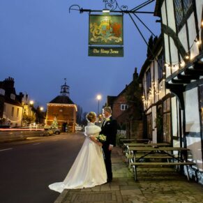 The Medieval High Street in Old Amersham is so picture perfect for wedding photo opportunities, and even more so after dark! For this shot I'm using my floodlighting to really elevate this capture of the newlyweds in front of their Kings Chapel wedding venue, then after this pose we ventured further along the high street to stop off at a few more striking locations. For this shot I've photo-shopped out the yellow lines from the street, these were a little too distracting for this dramatic pose. The newlyweds captured in Old Amersham High Street outside their Kings Chapel wedding reception venue at dusk