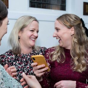 Giggles are not in short supply for these two ladies at this Kings Chapel wedding reception in Old Amersham