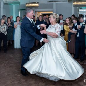 The newlyweds perform their energetic first dance to an appreciative audience at their Kings Chapel wedding reception in Old Amersham