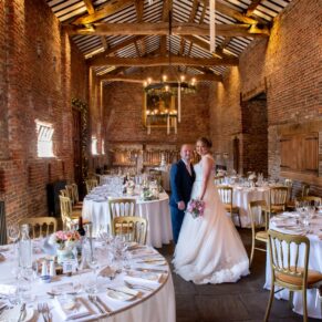 The newlyweds inside the huge barn just prior to the meal at their Meols Hall wedding reception