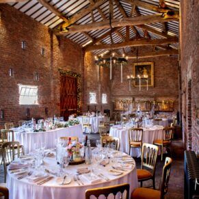 A wide view of the stunning barn interior at Meols Hall captured just prior to the wedding breakfast