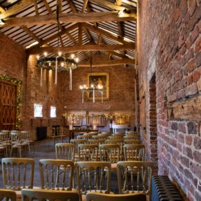 A wide view of the grand interiors Meols Hall barn prior to the wedding ceremony