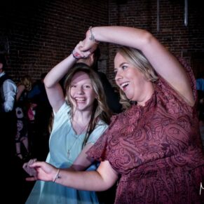 Two ladies captured on the dance-floor during the evening wedding reception at Meols Hall