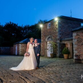 A floodlit pose of the newlyweds at their Meols Hall wedding