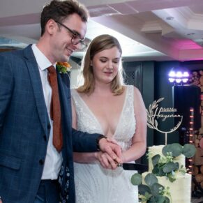 The bride and groom cut the cake on the dance-floor just prior to their first dance