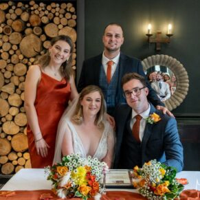 Signing of the register captured during the civil ceremony at The Manor House Hotel in Moreton-in-Marsh