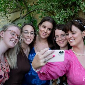 Five sisters pose for a relaxed selfie picture in hotel's lovely gardens