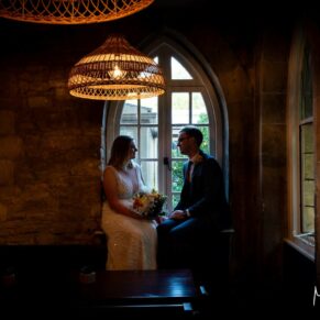 A silhouette pose of the newlyweds captured in a feature window inside the hotel