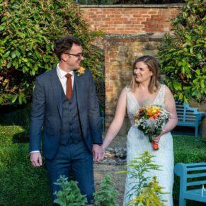The newlyweds take a stroll in the gardens of this stunning Cotswolds venue