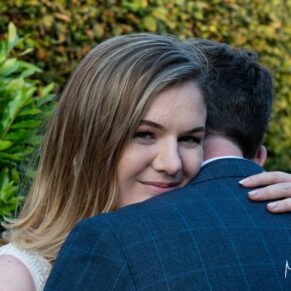 The bride hugs her husband during her Manor House Hotel wedding reception in Moreton-in-Marsh