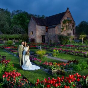 Chenies Manor is a dream location for my style of colourful photography on a wedding wedding day, and especially so during tulip season! This pose it's pretty straightforward to capture during daylight hours, but it takes on a whole new dimension when captured at night-time with floodlighting. By using my directional lights I'm really boosting the wow factor effect that you see in this finished image, and the end result is pretty surreal and dramatic. Dramatic dusk portrait of the bride and groom in the colourful sunken gardens at their Chenies Manor spring wedding