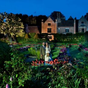 Once dusk arrives I bring out my floodlights to create a few wow factor images with the newlyweds on their wedding day! And at Chenies Manor the backdrops don't get much better after dark. In this shot I've lit the sunken garden area and the newlyweds to create the dramatic image you see here amongst the tulips. I visited several locations with the bride and groom when the dusky blue skies were absolutely perfect. Dramatic dusk portrait of the bride and groom in the colourful spring gardens at their Chenies Manor wedding