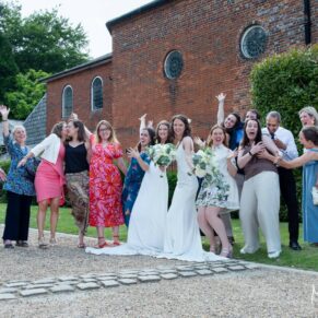 The wedding couple and their friends strike a pose outside The Kings Chapel's in Old Amersham