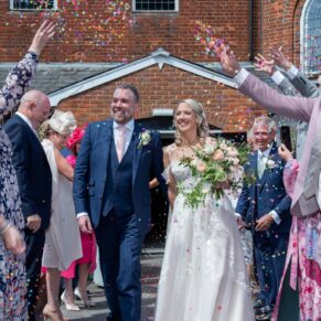 The newlyweds dash through the wedding confetti aisle after their Kings Chapel civil ceremony in Old Amersham