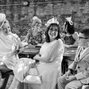 Candid capture of some family members during the wedding drinks reception at The Kings Chapel in Old Amersham