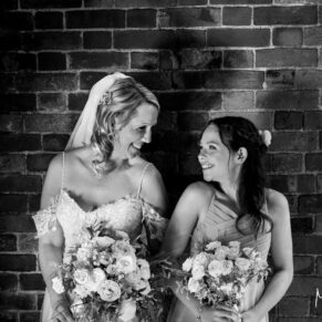 The bride with her bridesmaid captured with some dramatic lighting at her Kings Chapel Old Amersham wedding