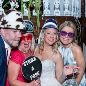 The newlyweds strike a pose with some friends in the photo-booth at their Kings Chapel Old Amersham wedding