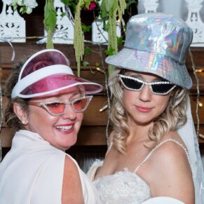 The bride and a girlfriend in the wedding photo-booth at The Kings Chapel in Old Amersham