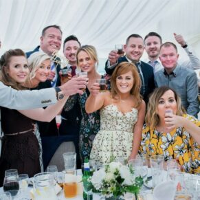 Buckinghamshire events photography of a lively group pose captured of a group of delegates around a table