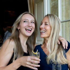 Buckinghamshire events photography of two ladies giggling away during the drinks reception at a corporate gathering