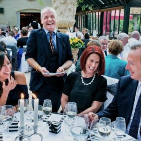 Buckinghamshire events photography of the magician weaving his magic on an appreciative audience