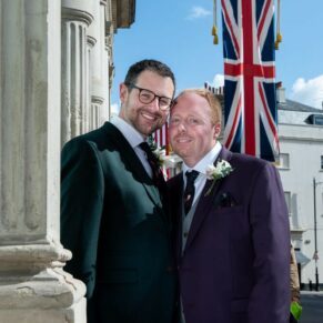 The happy newlyweds pose for the camera with in the High Street after their civil wedding ceremony inside the Windsor Guildhall